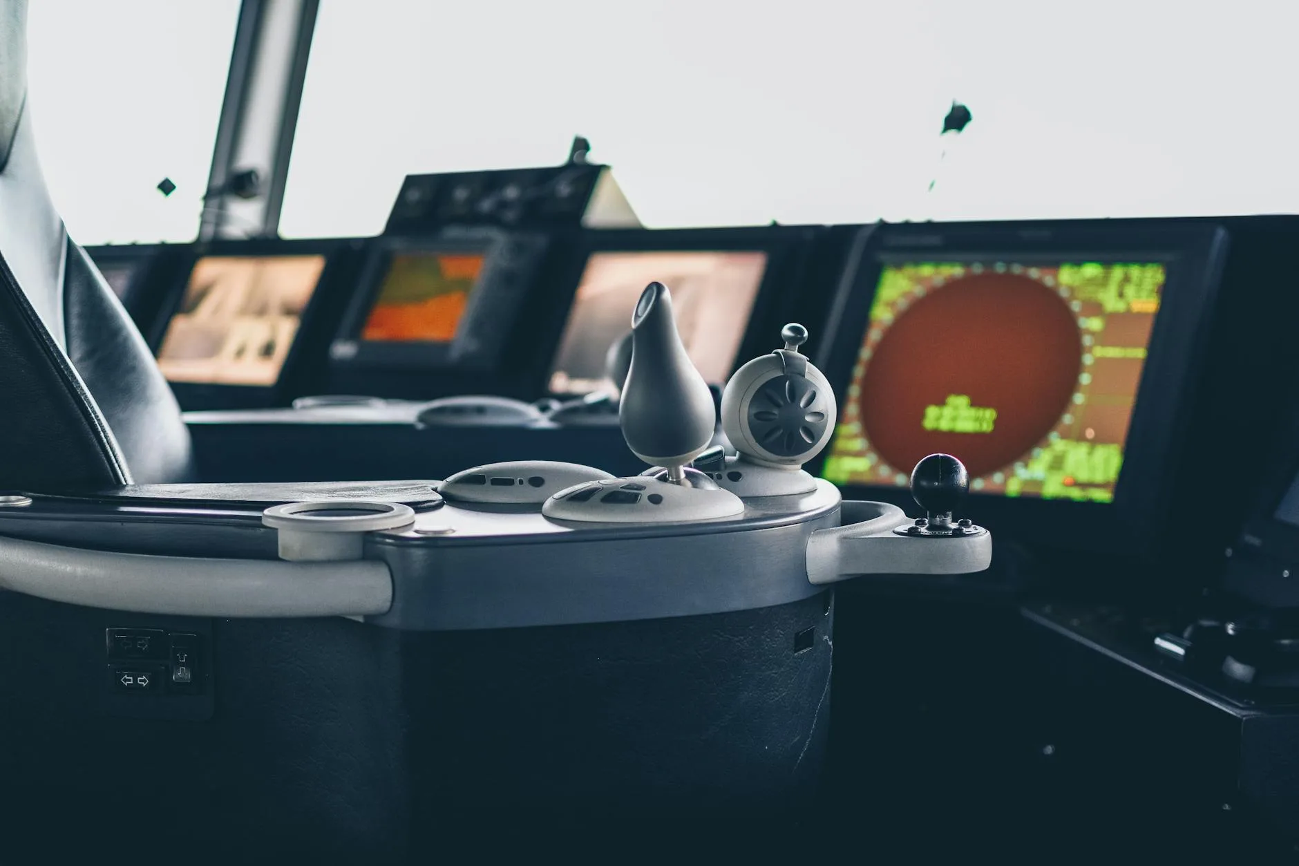 Mengenal Alat Navigasi Elektronik 2 Close-up view of ship navigation controls and radar screens, capturing maritime technology.